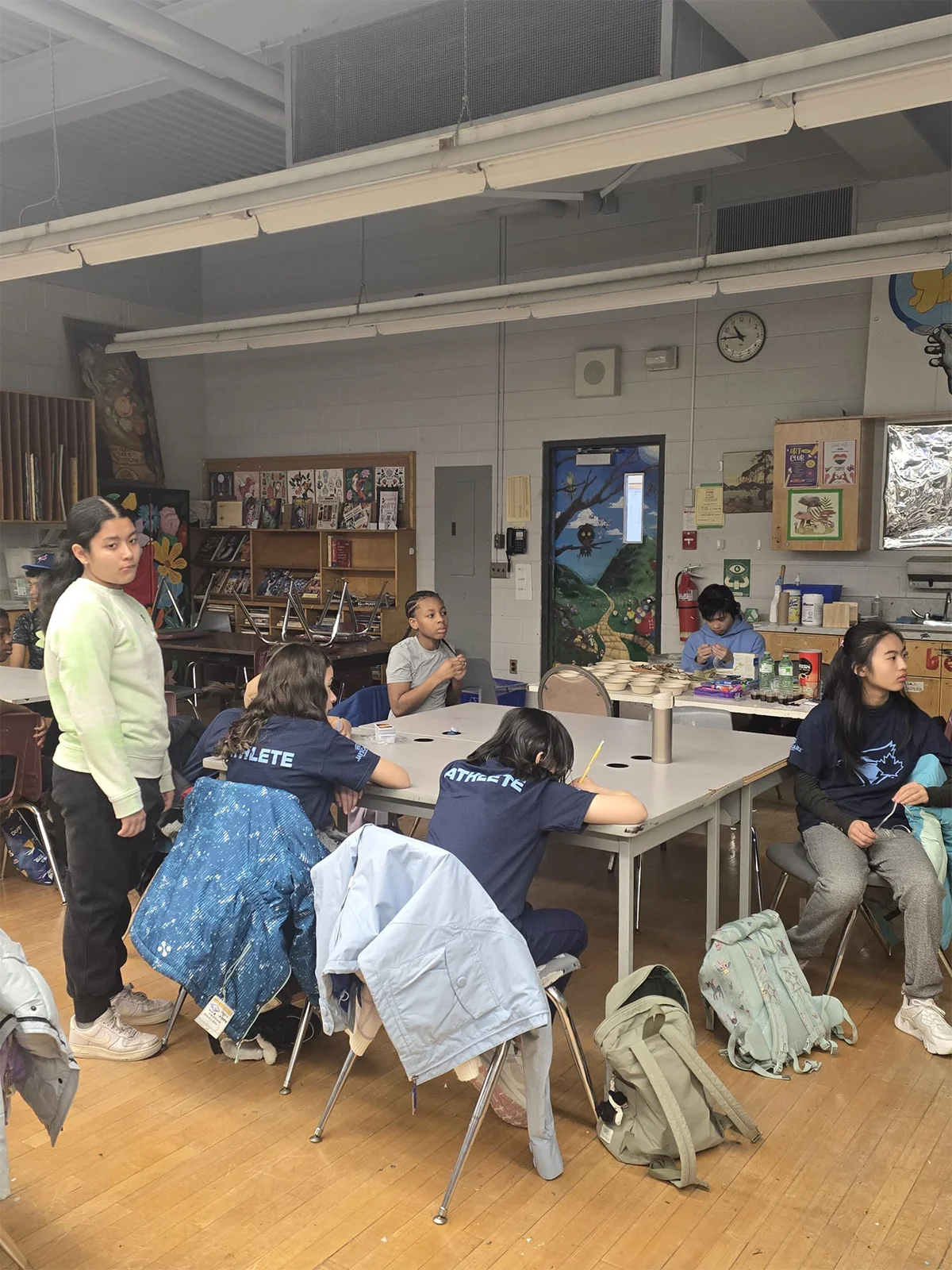 Young participants collaborating and building connections around the table
