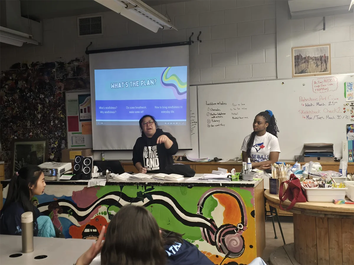 Facilitator explaining mindfulness techniques and grounding practices to participants