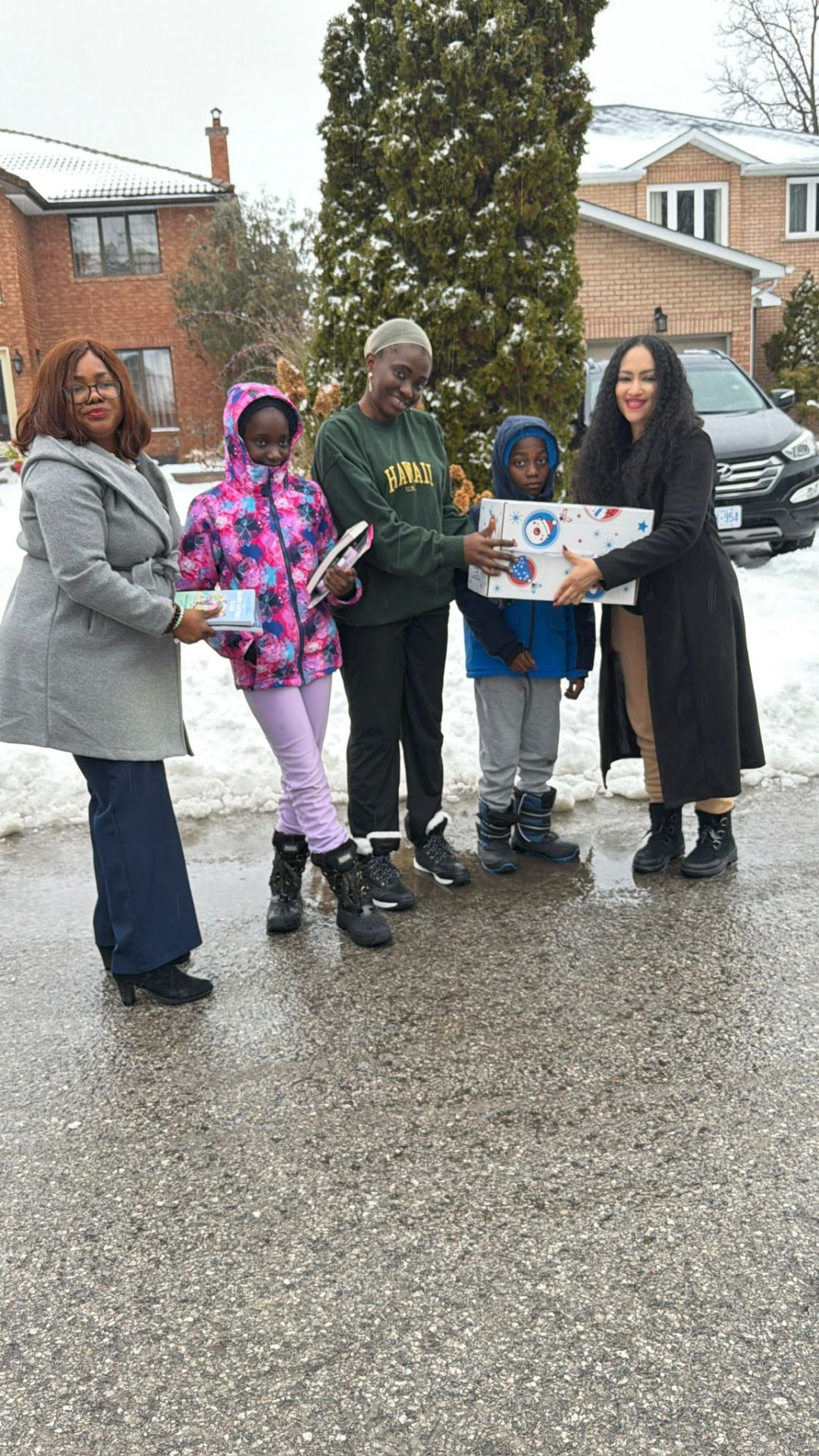 Community members sharing smiles and holiday care packages during winter outreach