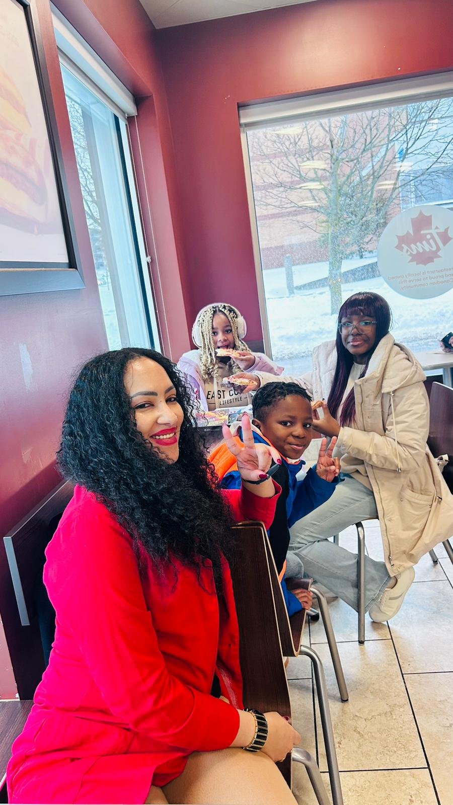 Community youth holding decorated gift hamper filled with holiday essentials
